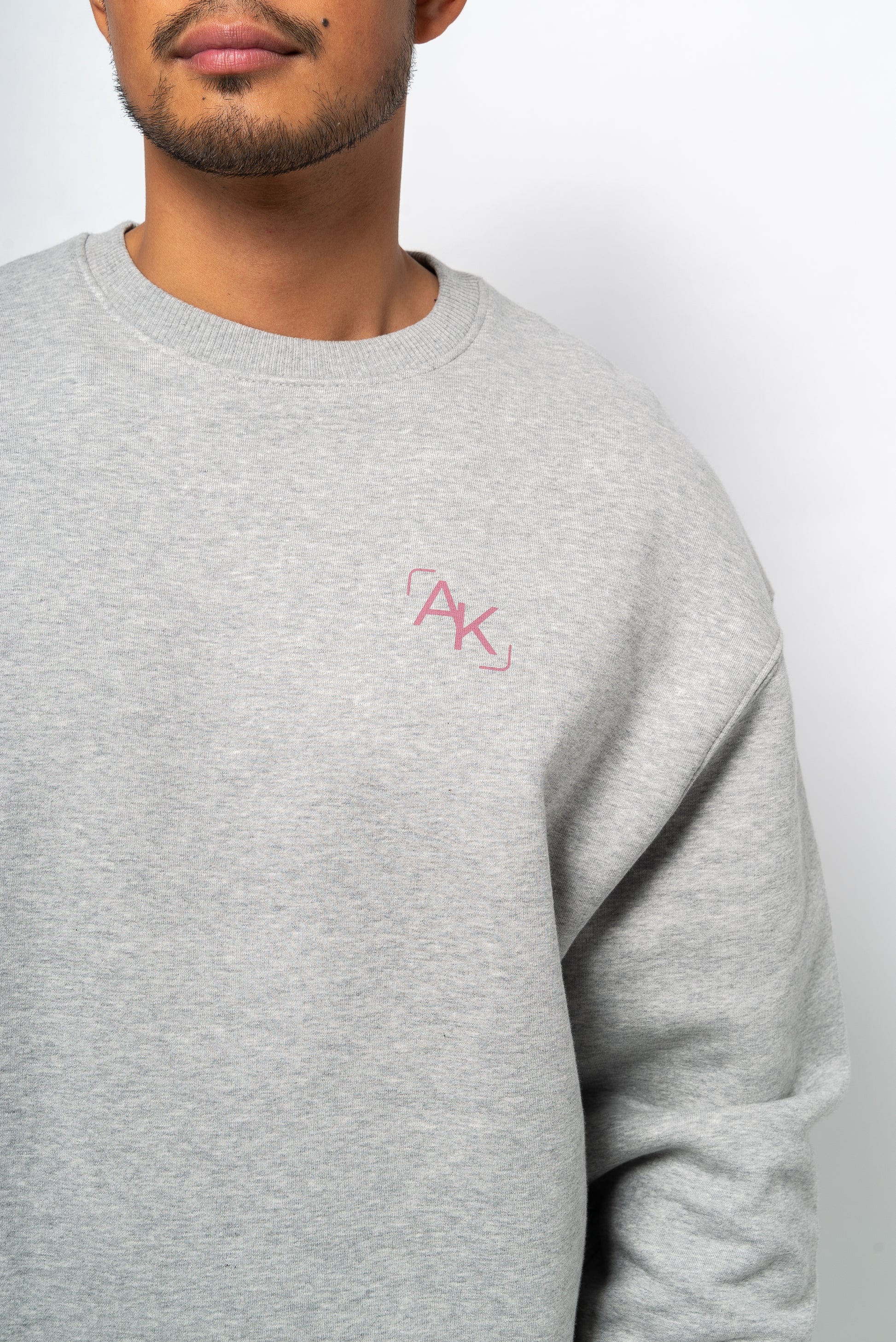 light grey sweatshirt and dusty pink logo